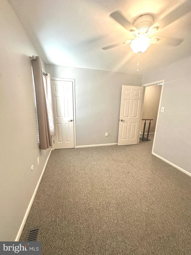 unfurnished bedroom with ceiling fan and carpet floors