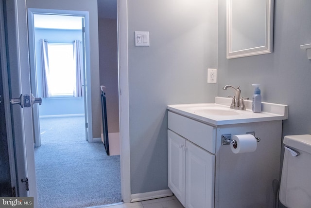 bathroom with toilet and vanity