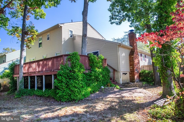 back of property with a wooden deck