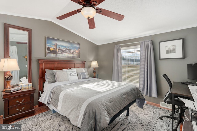 bedroom featuring ceiling fan, lofted ceiling, light hardwood / wood-style flooring, and crown molding