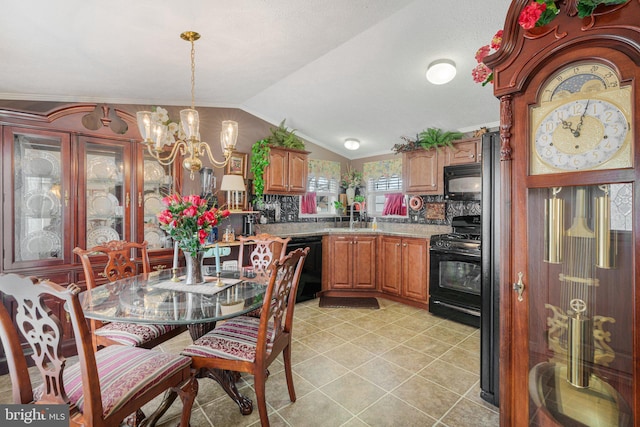 kitchen with pendant lighting, black appliances, lofted ceiling, tasteful backsplash, and a chandelier