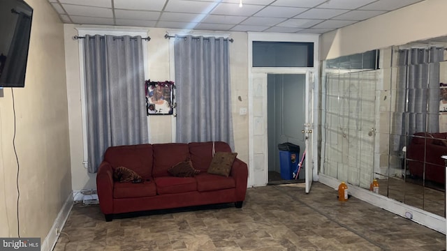 living room featuring a drop ceiling