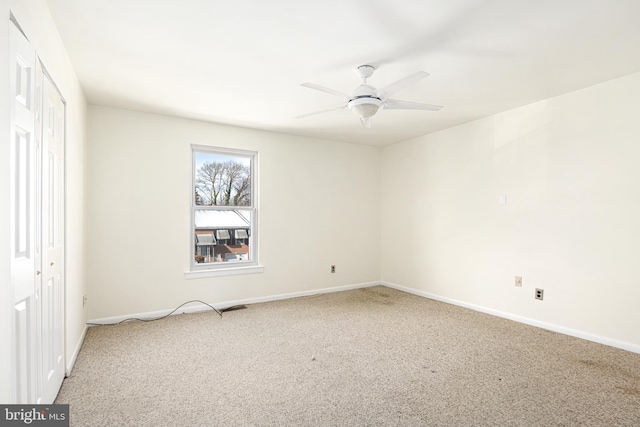 empty room with carpet floors and ceiling fan