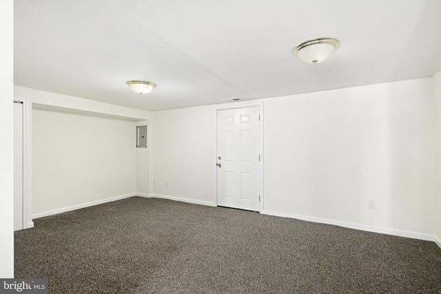 basement featuring dark colored carpet and electric panel