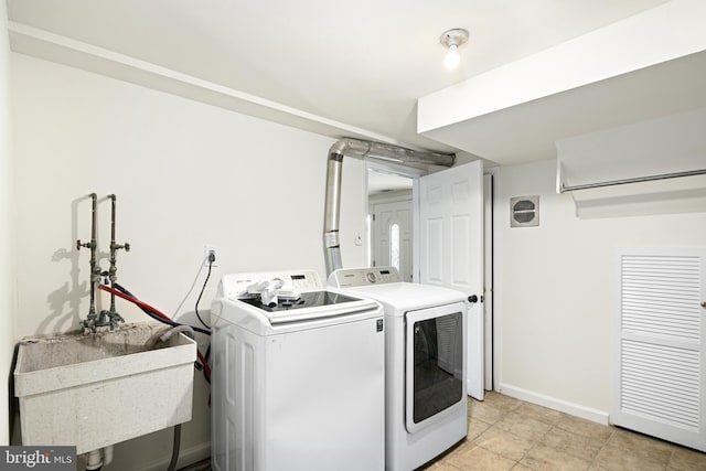 washroom featuring sink and washer and dryer