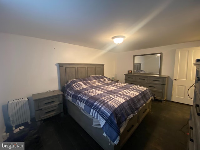 bedroom featuring dark wood-type flooring and radiator heating unit