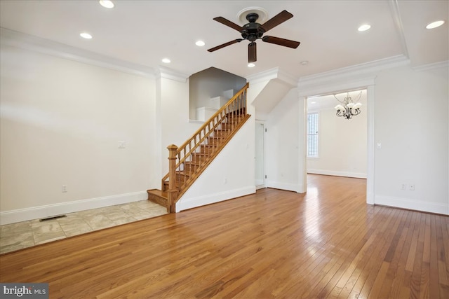 unfurnished living room featuring wood-type flooring, ceiling fan with notable chandelier, and ornamental molding