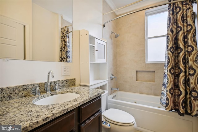 bathroom featuring toilet, shower / tub combo with curtain, and vanity