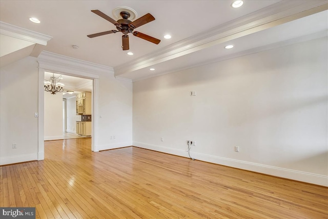 empty room with light wood-style flooring, recessed lighting, ceiling fan with notable chandelier, baseboards, and ornamental molding