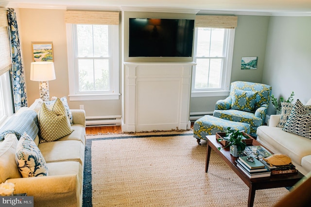 living room featuring baseboard heating, ornamental molding, and hardwood / wood-style flooring