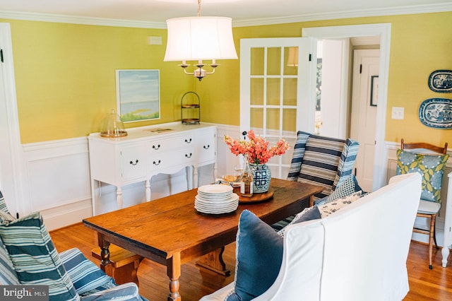 dining space with light hardwood / wood-style floors and ornamental molding