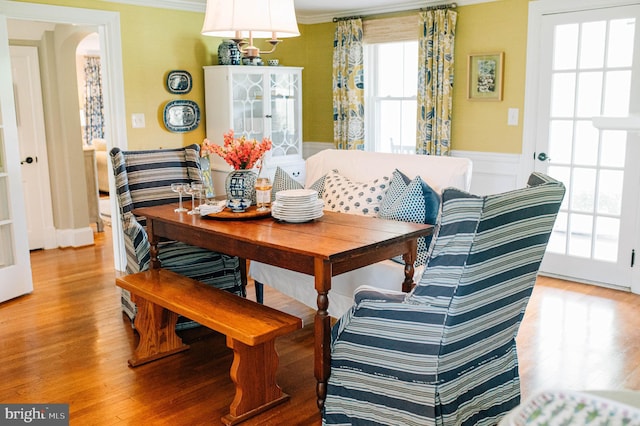 dining space featuring hardwood / wood-style floors and crown molding