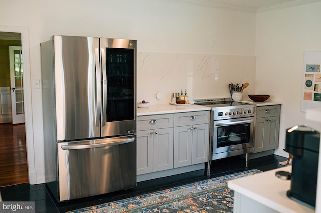 kitchen with stainless steel appliances, dark tile patterned floors, tasteful backsplash, and gray cabinetry