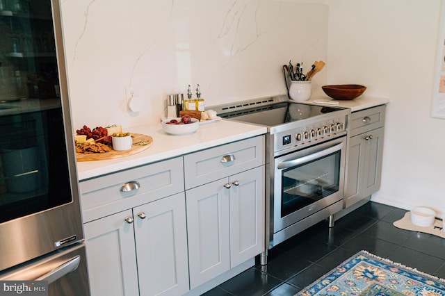 kitchen with electric range and dark tile patterned floors