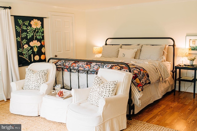 bedroom featuring hardwood / wood-style floors and crown molding