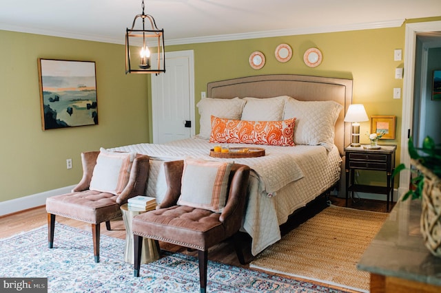 bedroom featuring hardwood / wood-style floors and ornamental molding