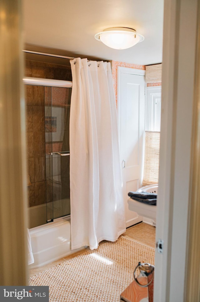 bathroom featuring washtub / shower combination and tile patterned floors