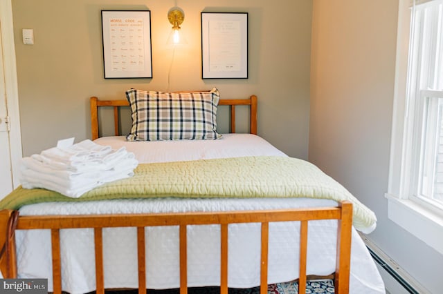 bedroom with a baseboard heating unit