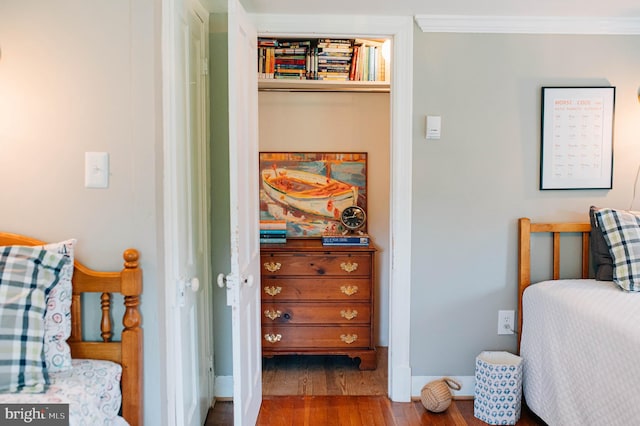 bedroom with hardwood / wood-style floors and crown molding