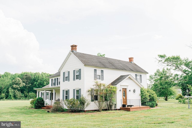 colonial-style house with covered porch and a front lawn