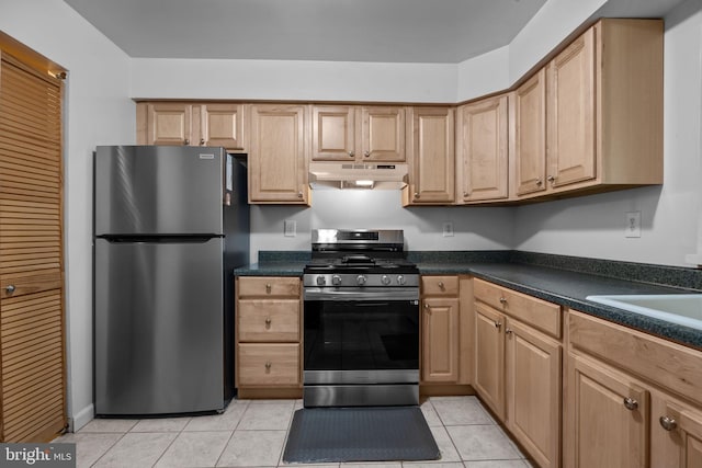 kitchen with light tile patterned floors, appliances with stainless steel finishes, and sink