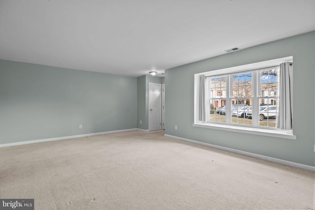 spare room with light colored carpet