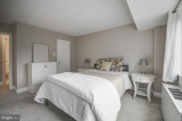 carpeted bedroom featuring ensuite bathroom