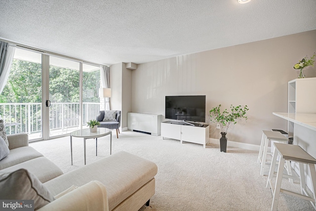 carpeted living room featuring expansive windows and a textured ceiling