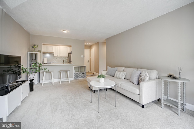 carpeted living room with a textured ceiling