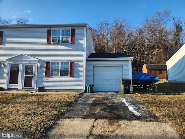 view of front of property with a garage and a front lawn