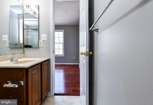 bathroom with baseboards and vanity