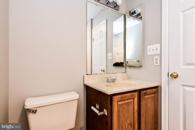 bathroom featuring toilet and vanity