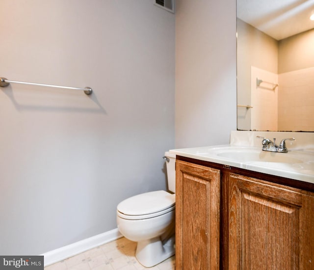 bathroom featuring toilet, visible vents, vanity, baseboards, and tile patterned floors