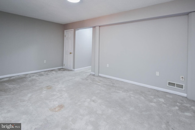 unfurnished bedroom featuring light colored carpet, visible vents, and baseboards