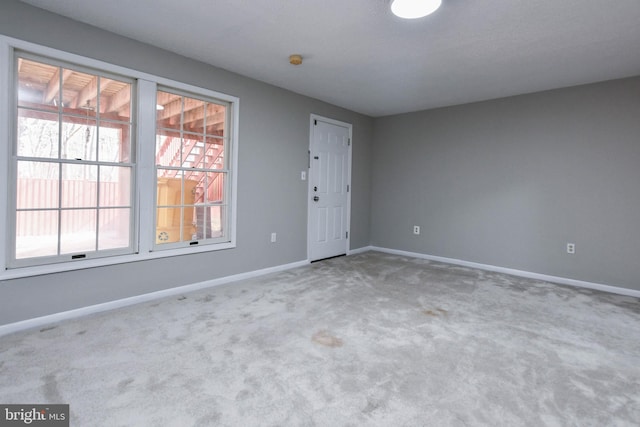 empty room with carpet floors and baseboards