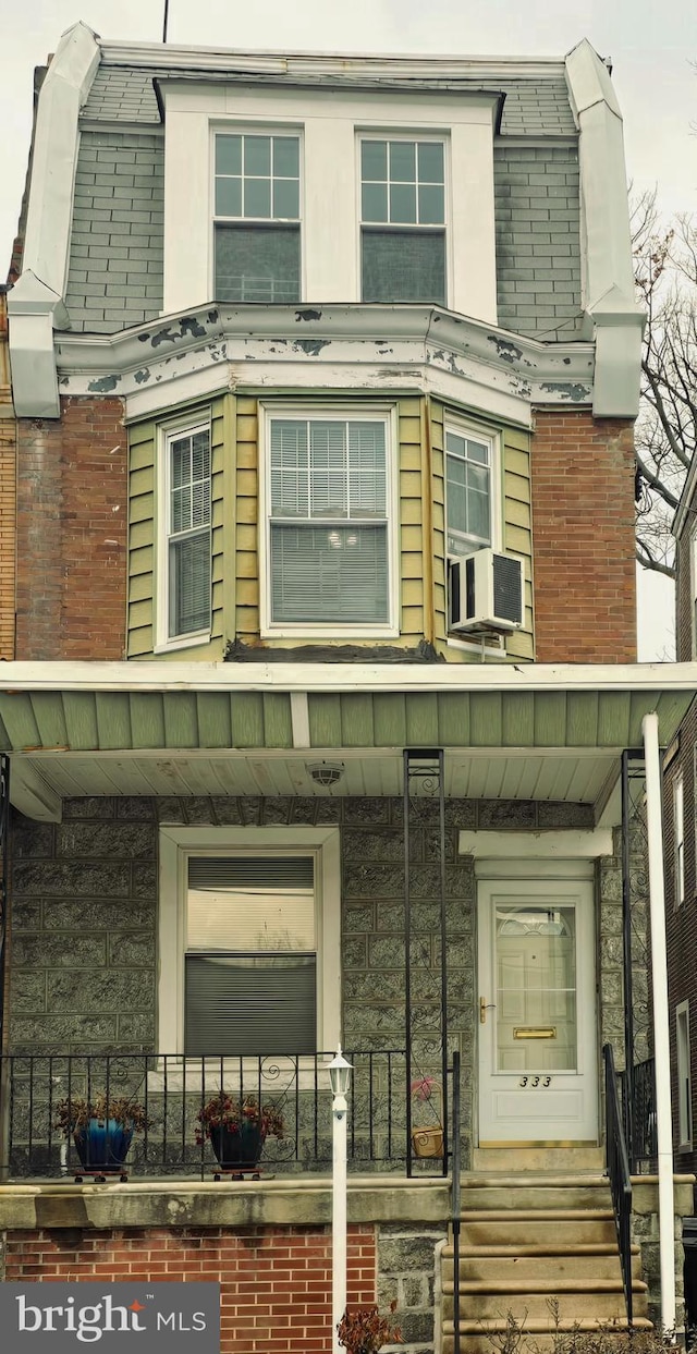 exterior space with cooling unit and a porch