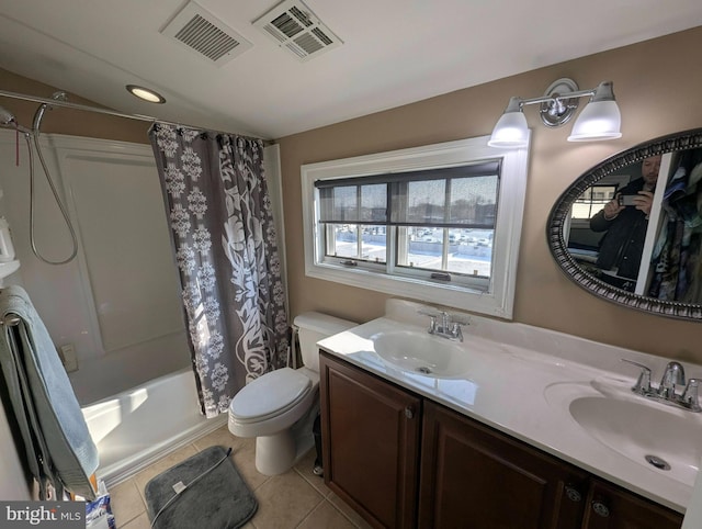 full bathroom with shower / tub combo, vanity, tile patterned flooring, and toilet