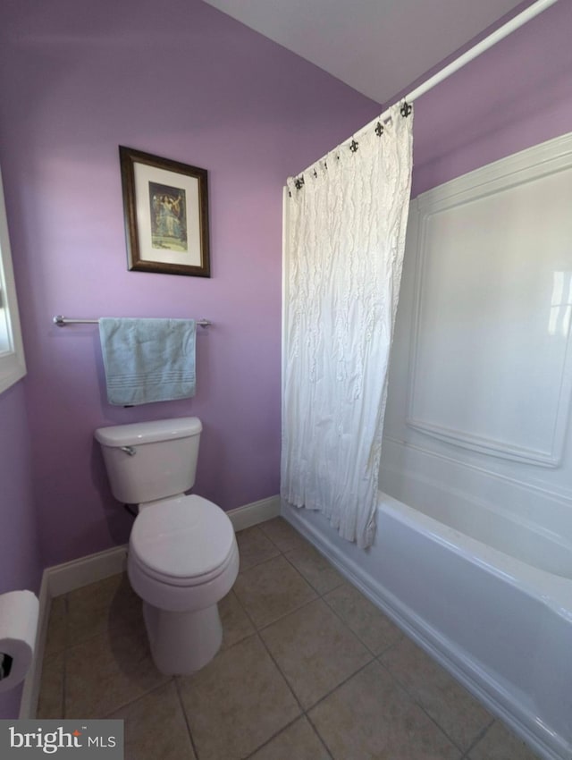 bathroom featuring toilet, shower / bath combo, and tile patterned flooring