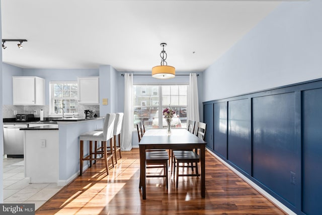 dining area with hardwood / wood-style flooring and a healthy amount of sunlight