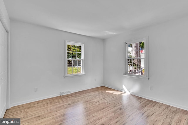 unfurnished room featuring light wood-type flooring