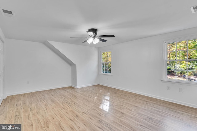 bonus room with ceiling fan and light hardwood / wood-style flooring