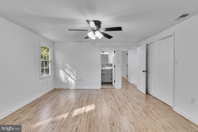 unfurnished living room with ceiling fan and light wood-type flooring