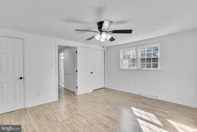 unfurnished bedroom featuring ceiling fan and light wood-type flooring