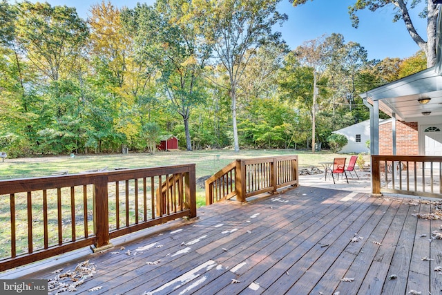 wooden deck with a lawn