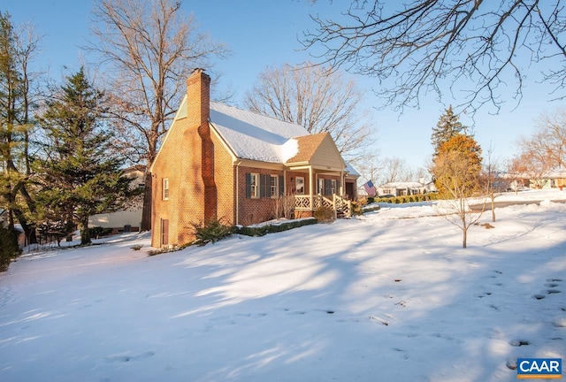 view of snow covered exterior featuring covered porch