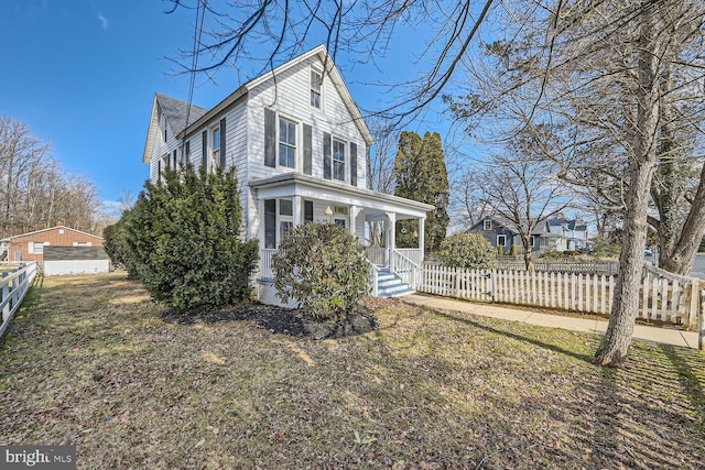 view of property exterior featuring covered porch and a lawn