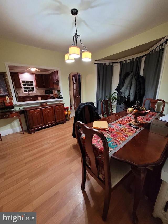 dining area with a chandelier and light wood-type flooring