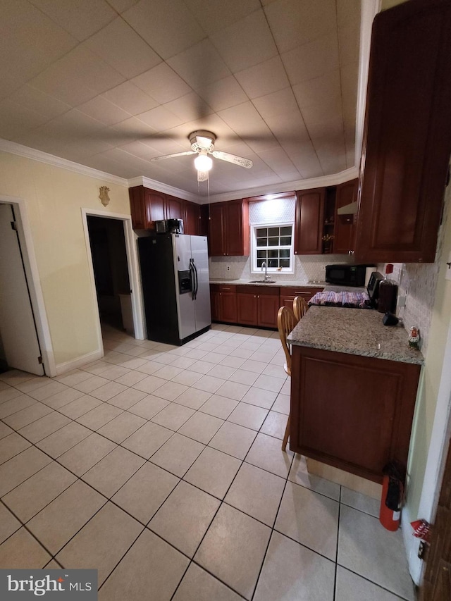 kitchen featuring stainless steel fridge with ice dispenser, light stone countertops, ornamental molding, ceiling fan, and sink