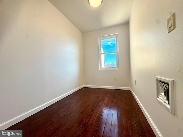 unfurnished room featuring dark wood-type flooring