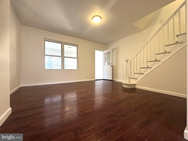 unfurnished living room featuring dark wood-type flooring